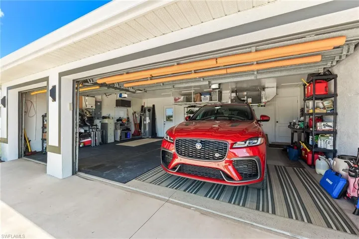 3 Car Garage featuring electric panel and water heater