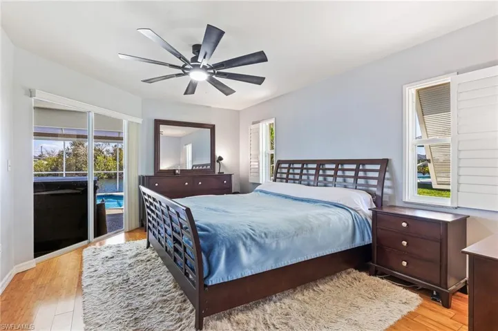 Bedroom with access to outside, light wood-style flooring, and ceiling fan