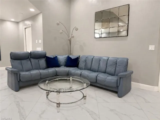 High ceilings, recessed lighting, and light-toned walls