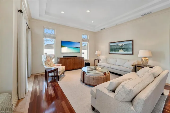 Living room featuring ornamental molding and hardwood / wood-style floors