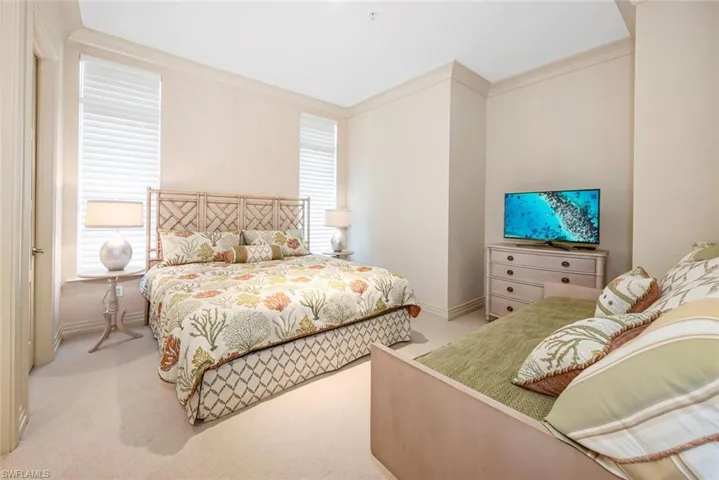 Bedroom featuring ornamental molding and light carpet