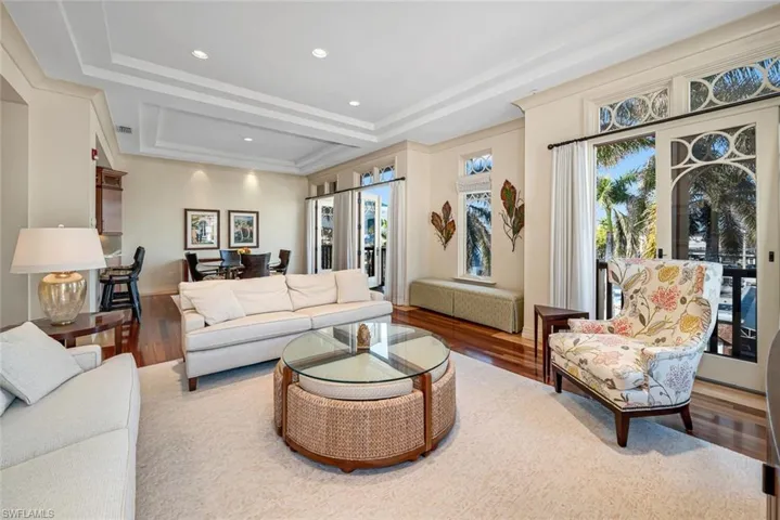 Living room featuring hardwood / wood-style floors and a raised ceiling