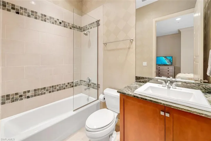 Full bathroom featuring vanity, toilet, and tiled shower / bath combo