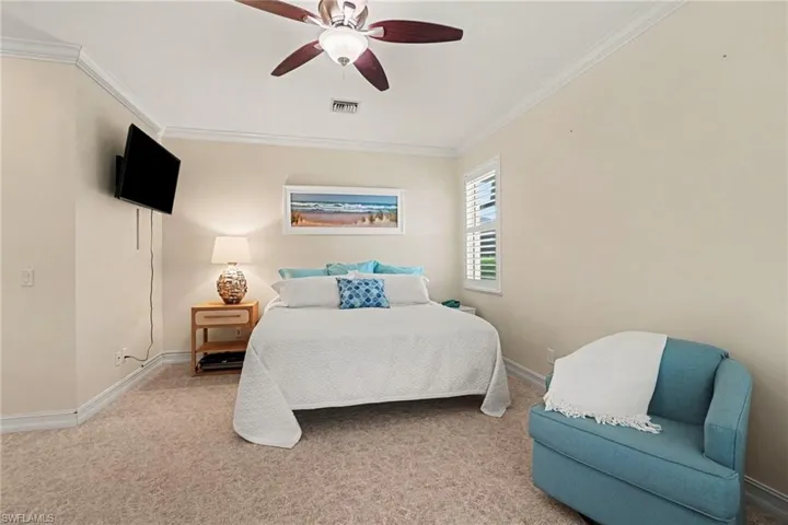 Spacious en-suite primary bedroom with dual walk-in closets, plush designer carpet