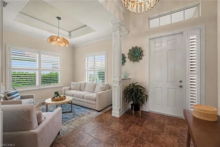 Gorgeous foyer entry flanked by elegant architectural detailing