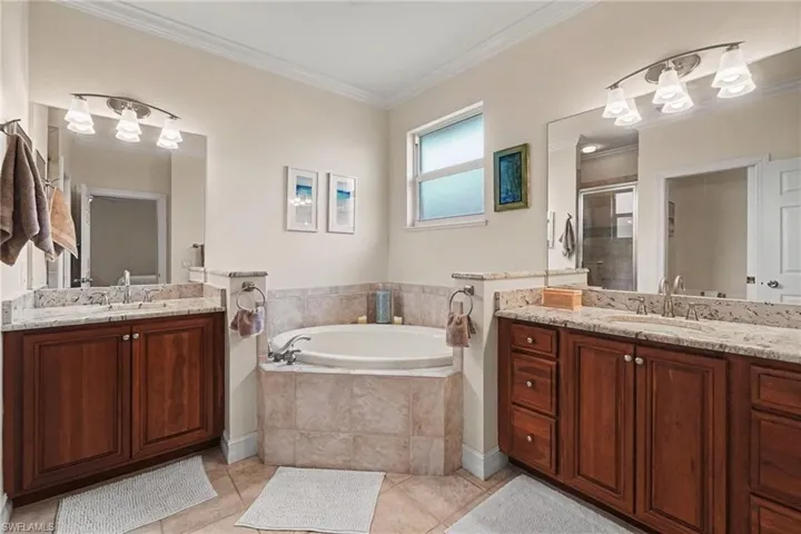 Dual vanities, soaking tub, separate shower, private room for toilet, linen closet