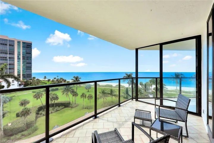 Balcony featuring a sunroom and a water view
