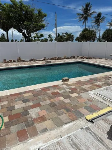 View of pool with a fenced backyard and a patio