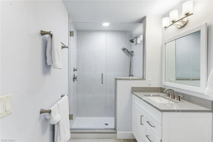 Guest bathroom with clean and crisp details- frameless glass walk-in shower with beautiful tile detail!