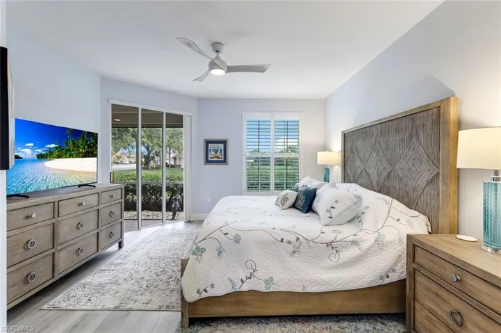 Spacious Primary bedroom with direct access to the lanai and plantation shutter framed windows with en-suite bathroom!