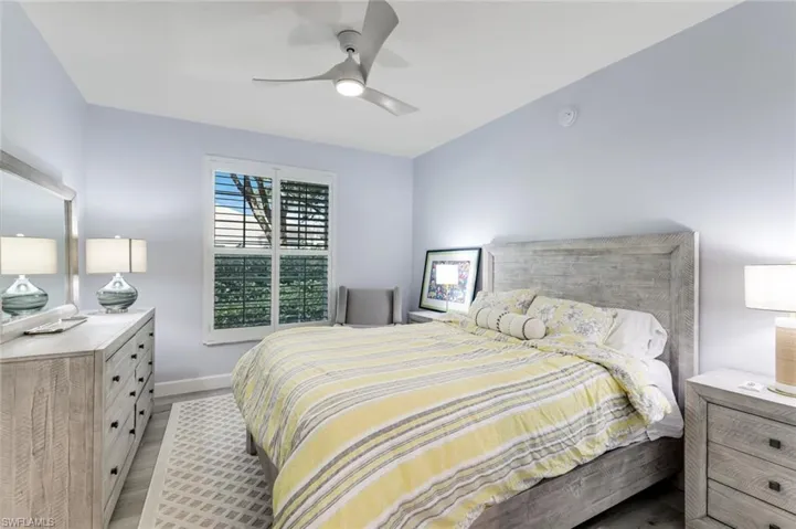 Spacious Guest bedroom #1 with ceiling fan and plantation shutter adorned window!