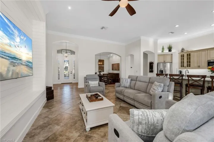 Light tile flooring with custom shiplap wall