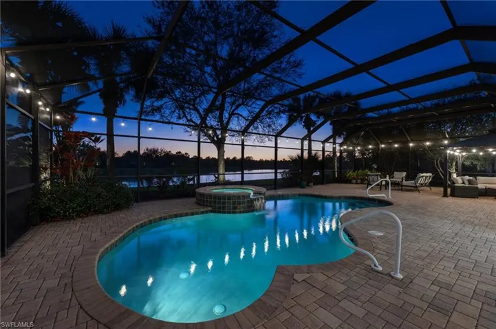 Night shot of lighted pool and lanai