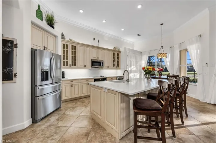 Custom cream cabinets with large quartz countertop