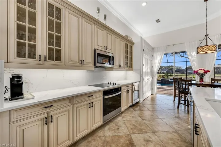 Custom cream cabinets with stainless steel appliances
