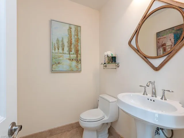 Half bathroom with toilet and tile patterned flooring