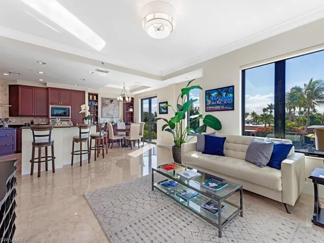 Living area featuring crown molding and a chandelier