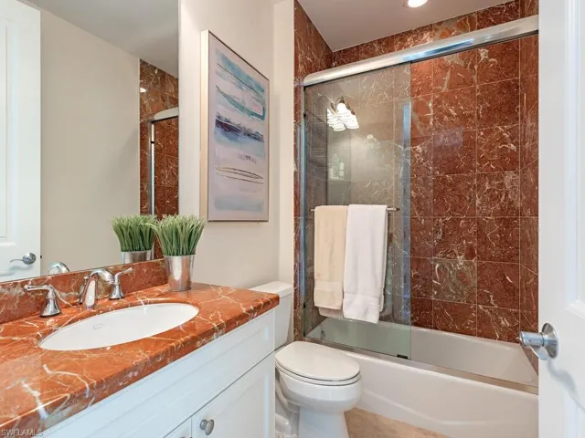 Full bathroom featuring vanity and enclosed tub / shower combo