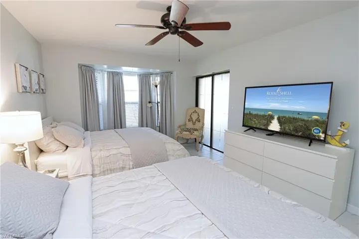 Bedroom with multiple windows and ceiling fan