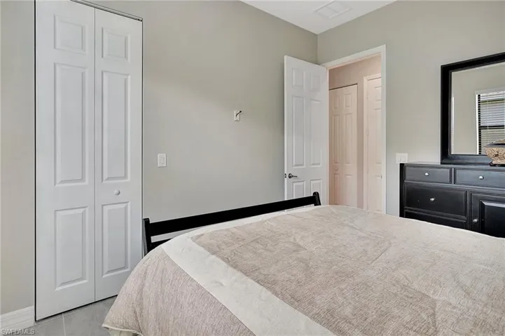 Bedroom with visible vents and a closet