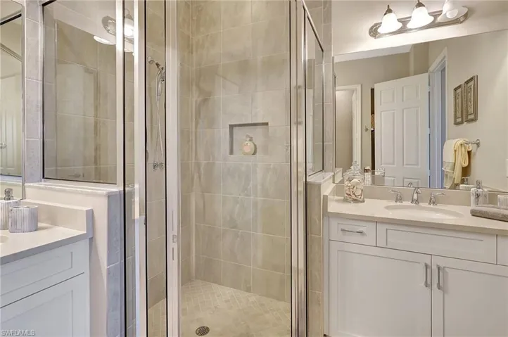 Bathroom featuring a stall shower and vanity