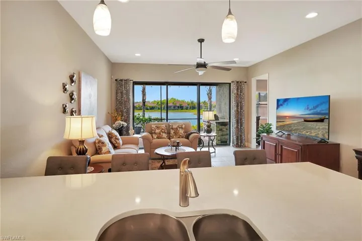 Kitchen featuring a ceiling fan, a sink, pendant lighting, and recessed lighting