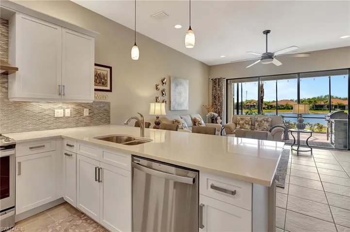 Kitchen featuring open floor plan, stainless steel appliances, a sink, visible vents, and a peninsula