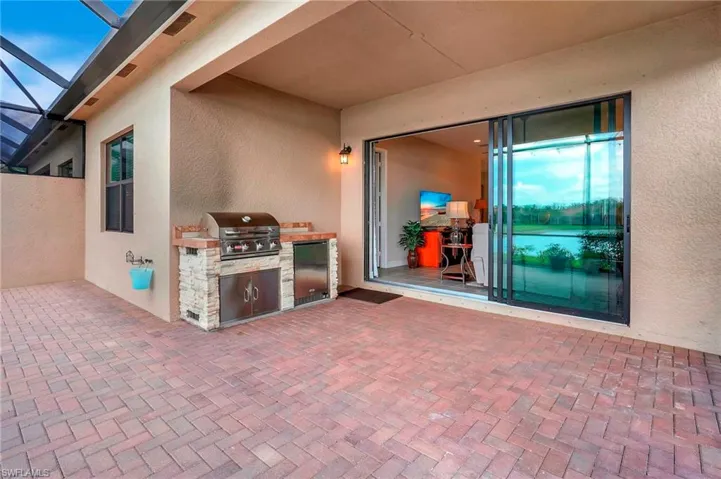 View of patio / terrace with a grill, visible vents, a lanai, and area for grilling
