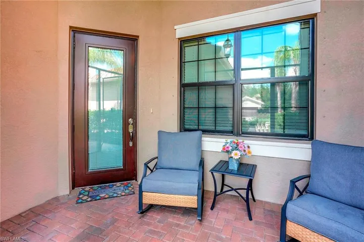 Entrance to property with stucco siding and a patio