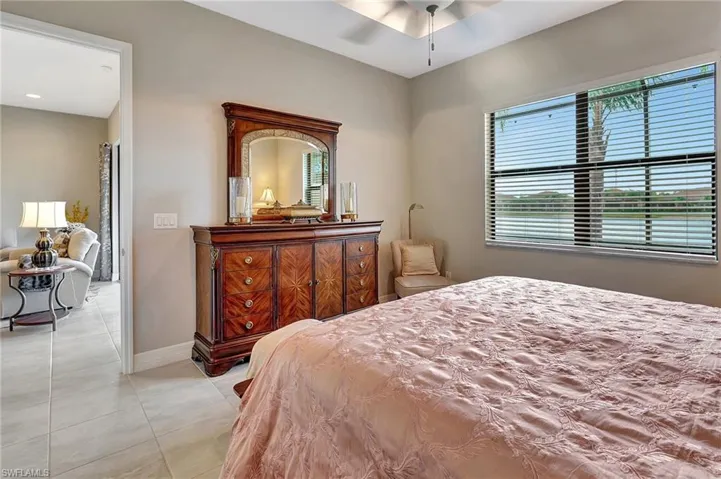 Bedroom with light tile patterned floors and baseboards