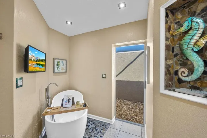 Soaking tub with view to private atrium