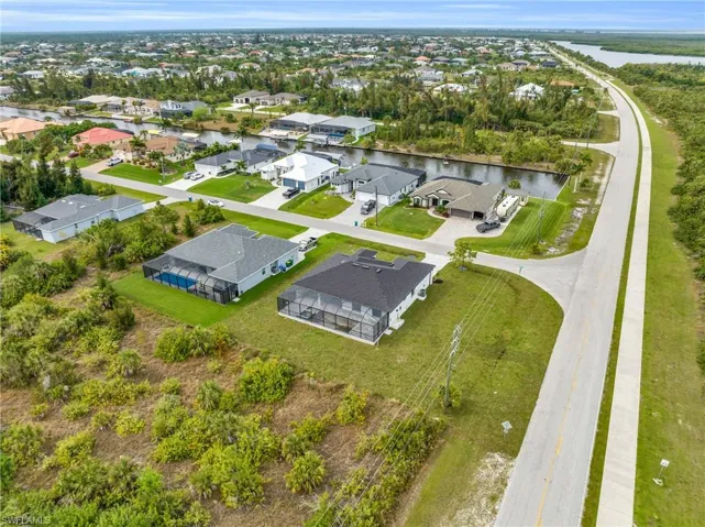 Aerial perspective of suburban area with a nearby body of water
