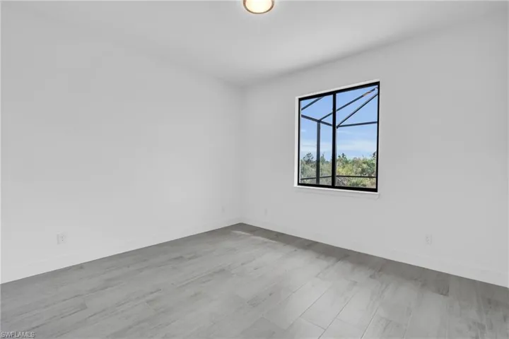 Empty room with wood finished floors and baseboards