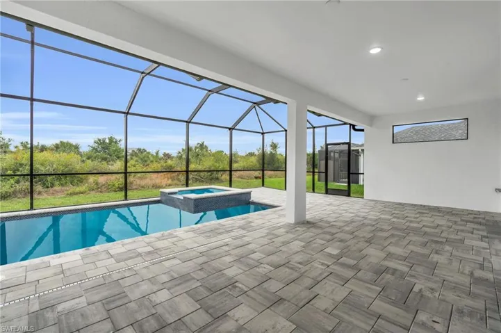 View of swimming pool with a lanai, a patio, and a pool with connected hot tub