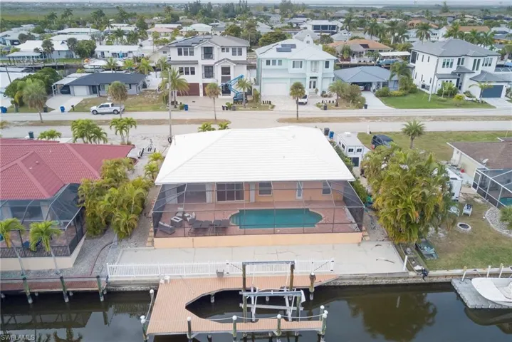 Aerial perspective of suburban area with a nearby body of water
