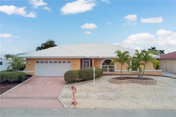 Single story home with stucco siding, driveway, and an attached garage