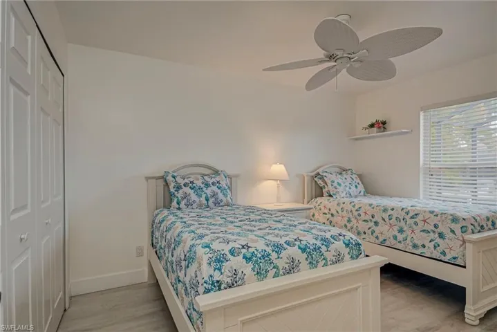 Bedroom with a closet, light wood-style flooring, and ceiling fan