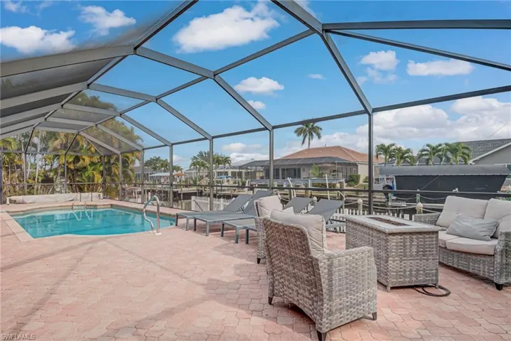 Swimming pool featuring glass enclosure and a sunroom