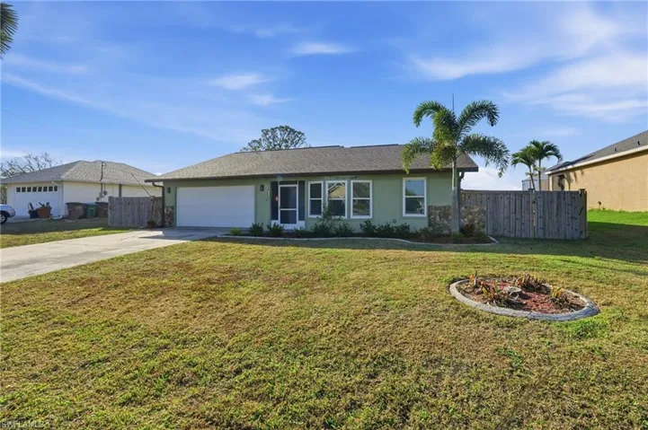 Single story home with concrete driveway, a garage, and stucco siding