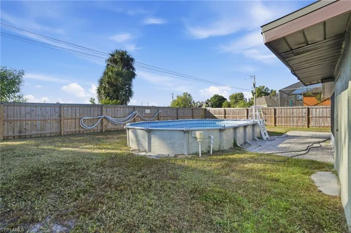 View of pool with patio surround and a fenced backyard