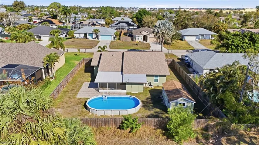 Aerial view of residential area featuring a pool