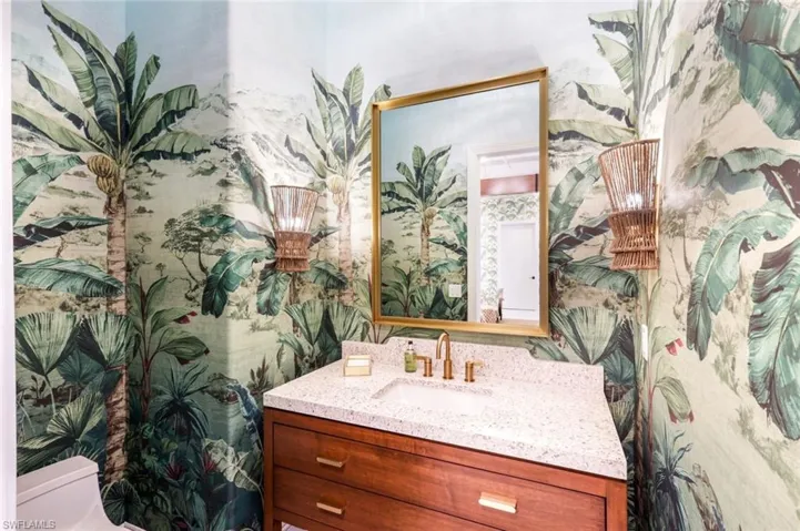 Bathroom with vanity and wallpapered walls