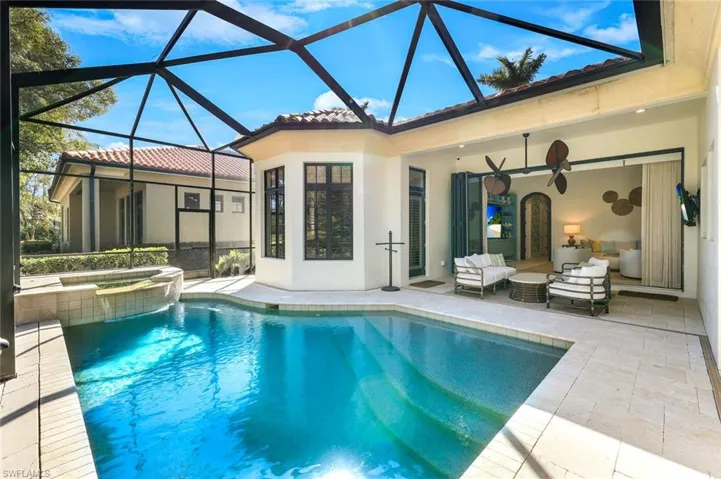 Combined pool / hot tub featuring a sunroom, a patio area, a lanai, and outdoor seating