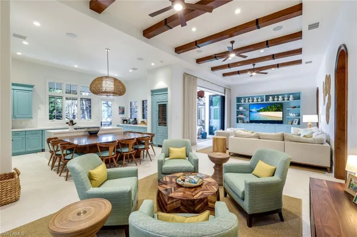 Living room featuring recessed lighting, beamed ceiling, and ceiling fan