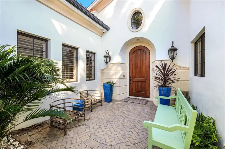 Doorway to property with stucco siding and a patio area