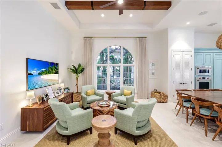 Sitting room featuring a raised ceiling, a ceiling fan, and recessed lighting