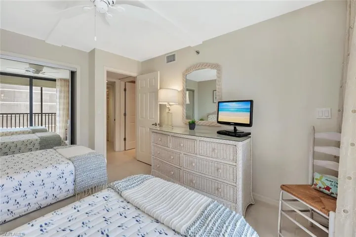 Bedroom featuring access to exterior, ceiling fan, and light colored carpet