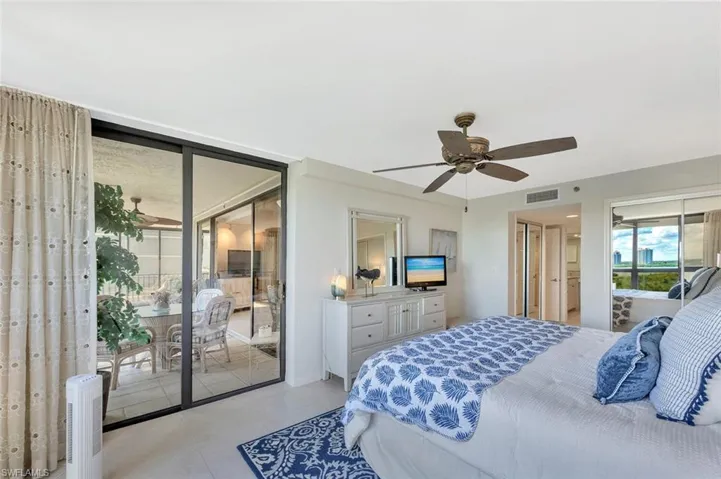 Tiled bedroom featuring access to outside and a ceiling fan
