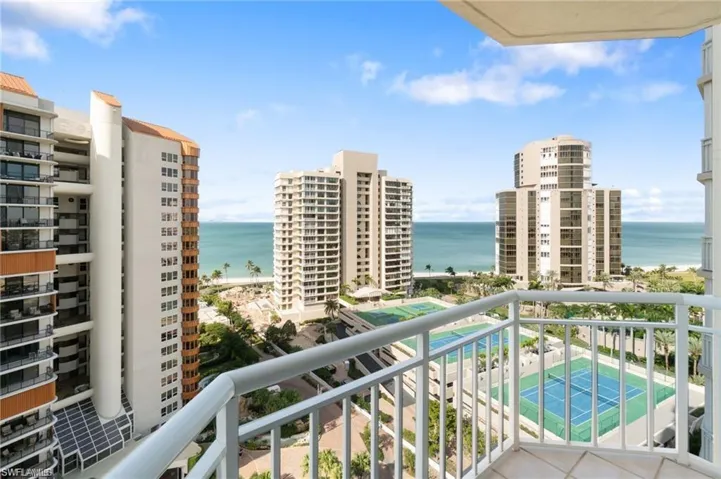 Balcony featuring a hot tub and a water view