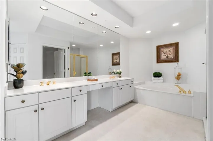 Bathroom featuring vanity and independent shower and bath